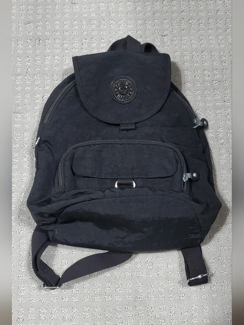 Kipling Queenie Small Backpack Black Nylon Brand Logo on the front flap.